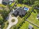An aerial shot of a two-story brick home with a pool, circular driveway, and well-maintained lawn at 9449 Freewoods Rd., Myrtle Beach, SC 29588