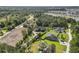 Aerial view of a neighborhood surrounded by dense foliage, a lake, and an open field at 9449 Freewoods Rd., Myrtle Beach, SC 29588