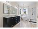 Modern bathroom with a double vanity, marble floors, a freestanding tub, and a glass shower at 9449 Freewoods Rd., Myrtle Beach, SC 29588
