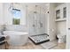 Bright bathroom with a freestanding tub, glass shower, and modern fixtures at 9449 Freewoods Rd., Myrtle Beach, SC 29588