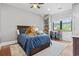 Cozy bedroom with a dark wood bed frame and built-in bookshelves near a bright window at 9449 Freewoods Rd., Myrtle Beach, SC 29588