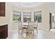 Bright breakfast nook features a round table, wooden chairs, and large windows with backyard views at 9449 Freewoods Rd., Myrtle Beach, SC 29588