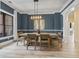 Dining room featuring wainscoting, statement chandelier, and access to the kitchen at 9449 Freewoods Rd., Myrtle Beach, SC 29588