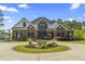 Beautiful brick two-story home featuring a circular driveway and manicured lawn at 9449 Freewoods Rd., Myrtle Beach, SC 29588