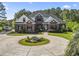 Beautiful brick two-story home featuring a circular driveway, manicured lawn, and boat parking at 9449 Freewoods Rd., Myrtle Beach, SC 29588
