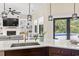 Open-concept kitchen and living area with stone countertops, modern lighting, and views of the backyard pool at 9449 Freewoods Rd., Myrtle Beach, SC 29588