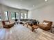 Bright living room features neutral walls, wood floors, a gray sofa, and two cozy armchairs at 9449 Freewoods Rd., Myrtle Beach, SC 29588