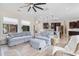 Open-concept living room with hardwood floors, modern light fixtures, and backyard views at 9449 Freewoods Rd., Myrtle Beach, SC 29588