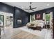Relaxing main bedroom with a fireplace, dark walls, hardwood floors, and backyard access at 9449 Freewoods Rd., Myrtle Beach, SC 29588