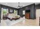 Dark accent wall and trim highlight the main bedroom with hardwood floors and natural light at 9449 Freewoods Rd., Myrtle Beach, SC 29588