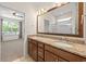 Bright bathroom with double sink vanity, granite countertop, and large framed mirror at 962 Witherbee Way, Little River, SC 29566