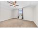 Spacious bedroom with neutral carpet, ceiling fan, and a window providing natural light at 962 Witherbee Way, Little River, SC 29566