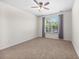 A simple, carpeted bedroom featuring a large window with natural light and neutral tones at 962 Witherbee Way, Little River, SC 29566