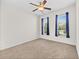 Bright bedroom with neutral carpet and two windows with blue curtains at 962 Witherbee Way, Little River, SC 29566