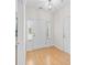 Bright foyer with hardwood floors, a white front door, and sidelights, creating a welcoming entrance at 962 Witherbee Way, Little River, SC 29566
