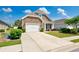 Inviting home with a stone facade, complemented by a lush lawn and a spacious driveway leading to the garage at 962 Witherbee Way, Little River, SC 29566