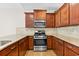 Modern kitchen with granite countertops, stainless steel appliances, dark wood cabinets, and hardwood floors at 962 Witherbee Way, Little River, SC 29566