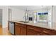 Island kitchen with granite countertops, stainless steel appliances, dark wood cabinets, and hardwood floors at 962 Witherbee Way, Little River, SC 29566