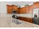 Well-equipped kitchen featuring granite countertops, dark wood cabinetry, and stainless steel appliances for a stylish look at 962 Witherbee Way, Little River, SC 29566