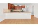 Close-up of a modern kitchen with stainless steel appliances, granite countertops, and hardwood floors at 962 Witherbee Way, Little River, SC 29566