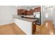 Modern kitchen with granite countertops, stainless steel appliances, dark wood cabinets, and hardwood floors at 962 Witherbee Way, Little River, SC 29566