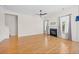 Spacious living room with hardwood floors, fireplace, ceiling fan, and staircase in a bright home at 962 Witherbee Way, Little River, SC 29566
