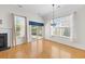 A bright living area featuring hardwood floors, fireplace, large windows, and sliding glass doors at 962 Witherbee Way, Little River, SC 29566