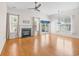 Cozy living room with hardwood floors, a fireplace, and large windows offering natural light at 962 Witherbee Way, Little River, SC 29566
