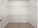 Organized walk-in closet with carpeted floors and metal shelving for storage at 962 Witherbee Way, Little River, SC 29566