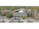 Aerial view featuring a sprawling building surrounded by lush greenery and ample parking at 9628 Indigo Creek Blvd., Murrells Inlet, SC 29576