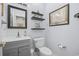 Powder room features a modern vanity with gray cabinets and stylish decor at 9628 Indigo Creek Blvd., Murrells Inlet, SC 29576
