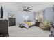 Light blue bedroom with a ceiling fan, carpeted floors, and two side tables at 9628 Indigo Creek Blvd., Murrells Inlet, SC 29576