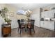 Cozy dining area with a glass table, chandelier, and natural light from the large window at 9628 Indigo Creek Blvd., Murrells Inlet, SC 29576