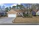 Charming brick home with a well-manicured lawn and attached two-car garage, offering classic curb appeal at 9628 Indigo Creek Blvd., Murrells Inlet, SC 29576