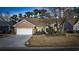 Charming brick home with a well-manicured lawn, a two-car garage, and inviting curb appeal at 9628 Indigo Creek Blvd., Murrells Inlet, SC 29576