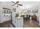 Cozy kitchen featuring white cabinets, an island, and a dining area with natural light streaming through the window at 9628 Indigo Creek Blvd., Murrells Inlet, SC 29576