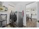 Laundry room featuring modern washer and dryer units next to a doorway at 9628 Indigo Creek Blvd., Murrells Inlet, SC 29576