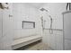 Modern shower with bench, rainfall shower head, and stylish tile design at 9628 Indigo Creek Blvd., Murrells Inlet, SC 29576