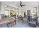 Cozy sunroom with wicker furniture, decorative windows, and a ceiling fan at 9628 Indigo Creek Blvd., Murrells Inlet, SC 29576