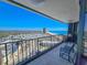 Enjoy panoramic ocean views from this condo's spacious balcony, featuring a charming tile floor and comfortable seating at 9650 Shore Dr. # 2007, Myrtle Beach, SC 29572