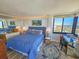 Bright bedroom featuring a queen-sized bed with striking blue patterned bedding and a view of the surrounding landscape at 9650 Shore Dr. # 2007, Myrtle Beach, SC 29572