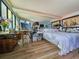 Bedroom with mirrored wall, desk and painting easel, wood floors, and neutral decor at 9650 Shore Dr. # 2007, Myrtle Beach, SC 29572