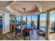 Elegant dining room featuring a glass table, stylish chandelier, and panoramic views at 9650 Shore Dr. # 2007, Myrtle Beach, SC 29572