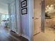 Hallway view leading to a well-lit bedroom and bathroom featuring artistic decor and updated fixtures at 9650 Shore Dr. # 2007, Myrtle Beach, SC 29572