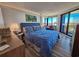 Comfortable main bedroom with a large bed, sitting area, and expansive windows showcasing beautiful views at 9650 Shore Dr. # 2007, Myrtle Beach, SC 29572