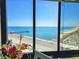 Expansive ocean view from the large window with flowers in the foreground at 9650 Shore Dr. # 2007, Myrtle Beach, SC 29572