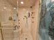 Modern shower with multiple shower heads, a built-in seat, and glass doors at 9650 Shore Dr. # 2007, Myrtle Beach, SC 29572