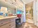 Elegant vanity area boasting ample storage and lighting, complemented by a stylish chair and access to the bathroom at 9650 Shore Dr. # 2007, Myrtle Beach, SC 29572