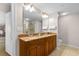 Well-lit bathroom with dual vanity, granite countertops, large mirror and separate shower at 9994 Beach Club Dr. # 2403, Myrtle Beach, SC 29572