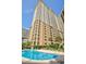 Stunning high-rise building with a beautiful pool and lush landscaping at 9994 Beach Club Dr. # 2403, Myrtle Beach, SC 29572